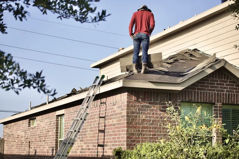 Professional roofer working on a residential roof in Lotville